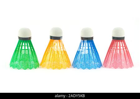 Four colorful synthetic badminton shuttlecocks in-line isolated on white background front view Stock Photo