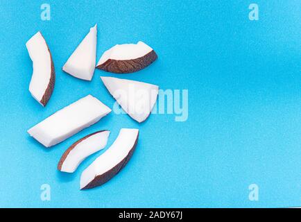 Coconut Pieces, Cut Coconut isolated on colored Background Stock Photo