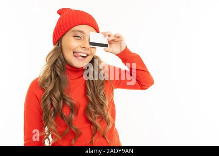 European girl with a cash card in hands on a white wall. Stock Photo