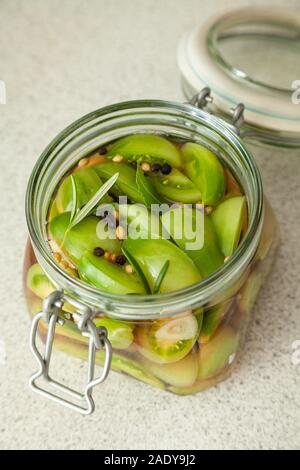 Homemade Pickled tomatoes in a glass jar Stock Photo