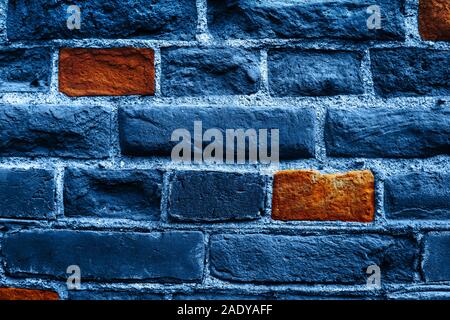 Close up image of old brick wall in blue color with some orange bricks. Background. Stock Photo