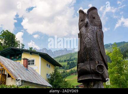 Wood carved owl in picturesque mountain town. Muhlbach am Hochkoenig. Stock Photo