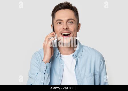 Head shot of happy smiling man talking via smart phone Stock Photo