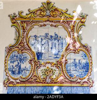 Detail of the beautiful polychromatic ceramic tiles panel depicting the various agricultural activities of a wealthy farm, in Tentugal, Coimbra, Portu Stock Photo