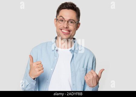 Young man with funny nerd jerk face showing thumb up Stock Photo