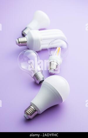 Energy saving and classic light bulbs on violet background. Stock Photo