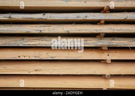 Wooden boards, lumber, industrial wood, timber. Building bar from a tree and an edging board in stacks. Stock Photo