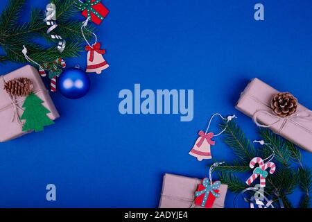 Christmas background with decorations and gift boxes on blue background. 2020. Stock Photo