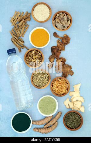 Herb and spice used in chinese herbal medicine to ease irritable bowel syndrome with dietary supplement powders and spring water. Flat lay. Stock Photo