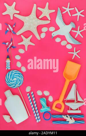 Summer holiday time abstract with composition of seashells, beach toys, symbols, rock candy and suntan protection lotion. Summer holiday themed concep Stock Photo