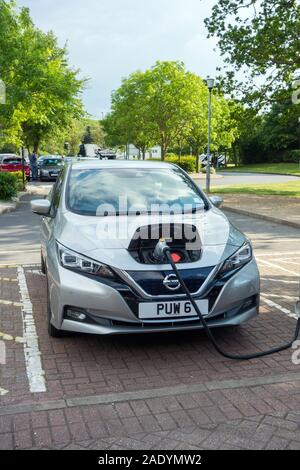 Nissan LEAF electric car being recharged at the recharging point at Warwick service station on the M 40 motorway  in England UK