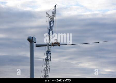 Madrid, Spain. 5th Dec, 2019. Mechanical cranes lift the blade of a wind turbine near the small village of Beltejar.Construction work continues on a new wind farm in Beltejar, north of Spain. Spain is the fifth country in the world to install wind power, after China, USA Germany and India. During COP25, the Spanish president Pedro Sanchez pledged to reduce the level of CO2 emissions by 20% in the next years. Credit: John Milner/SOPA Images/ZUMA Wire/Alamy Live News Stock Photo