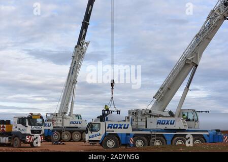 Madrid, Spain. 5th Dec, 2019. Mechanical cranes lift the blade of a wind turbine near the small village of Beltejar.Construction work continues on a new wind farm in Beltejar, north of Spain. Spain is the fifth country in the world to install wind power, after China, USA Germany and India. During COP25, the Spanish president Pedro Sanchez pledged to reduce the level of CO2 emissions by 20% in the next years. Credit: John Milner/SOPA Images/ZUMA Wire/Alamy Live News Stock Photo