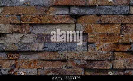 Background texture image of wall covered with rough shaped bricks. Stock Photo