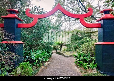 An ornate red and black gate serves as the entrance to the Asian-American Garden at Bellingrath Gardens, February 24, 2018, in Theodore, Alabama. Stock Photo