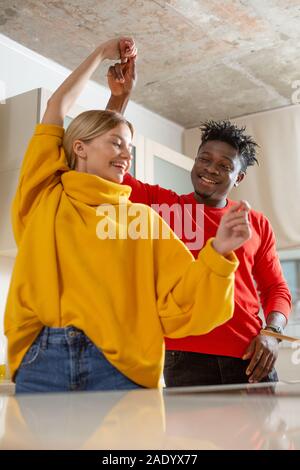 Waist up photo of two happy people dancing and smiling Stock Photo