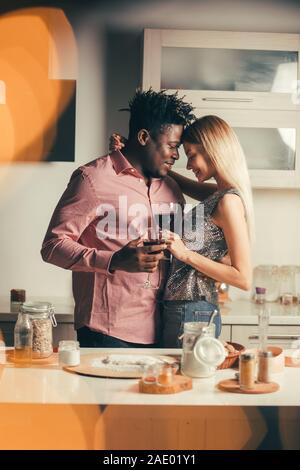 Two loving people holding glasses of wine and hugging Stock Photo