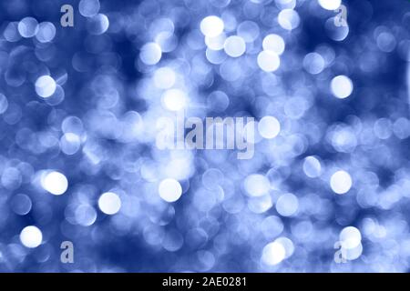 Blue twinkling lights bokeh light background. Color of the year. 2020 Stock Photo