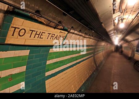 To The Trains sign, London Underground Tunnel, down in the Tube Station at midnight, London, South East England, UK Stock Photo