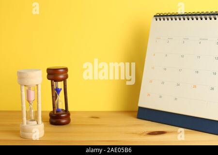 Calendar and hourglass on table, Business schedule and time concept Stock Photo