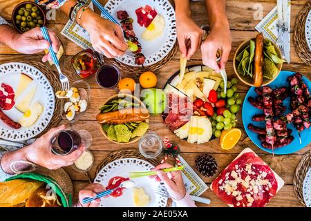 Above view of table full of coloured food for dinner or lunch activity concept - family caucasian people enjoying celebate together at home -winter ch Stock Photo