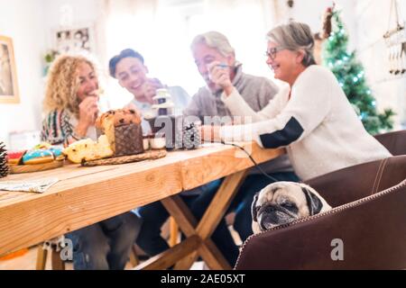 Group of people mixed ages generations like friends or caucasian cheeful family have fun all together at home during christmas celebrations - lazy sad Stock Photo