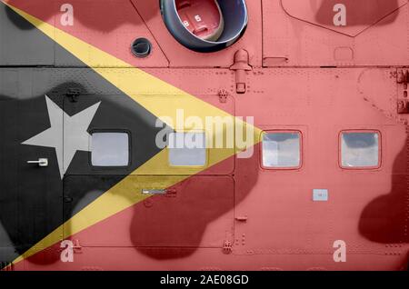 Timor Leste flag depicted on side part of military armored helicopter close up. Army forces aircraft conceptual background Stock Photo