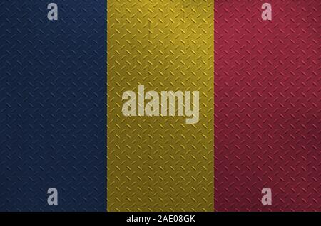 Chad flag depicted in paint colors on old brushed metal plate or wall close up. Textured banner on rough background Stock Photo