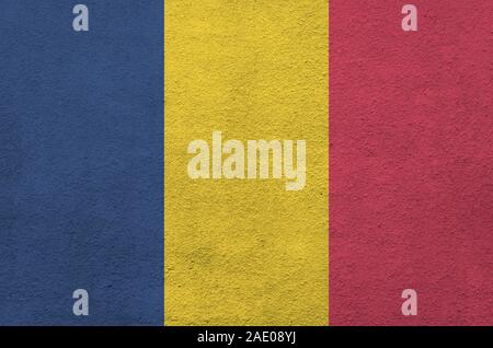 Chad flag depicted in bright paint colors on old relief plastering wall close up. Textured banner on rough background Stock Photo