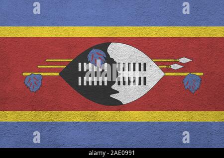 Swaziland flag depicted in bright paint colors on old relief plastering wall close up. Textured banner on rough background Stock Photo