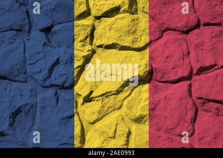 Chad flag depicted in paint colors on old stone wall close up. Textured banner on rock wall background Stock Photo