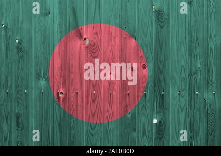 Bangladesh flag depicted in bright paint colors on old wooden wall close up. Textured banner on rough background Stock Photo