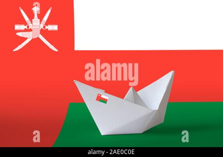 Oman flag depicted on paper origami ship closeup. Oriental handmade arts concept Stock Photo