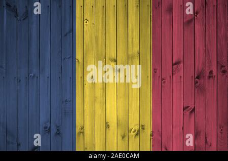 Chad flag depicted in bright paint colors on old wooden wall close up. Textured banner on rough background Stock Photo