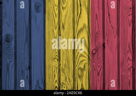 Chad flag depicted in bright paint colors on old wooden wall close up. Textured banner on rough background Stock Photo