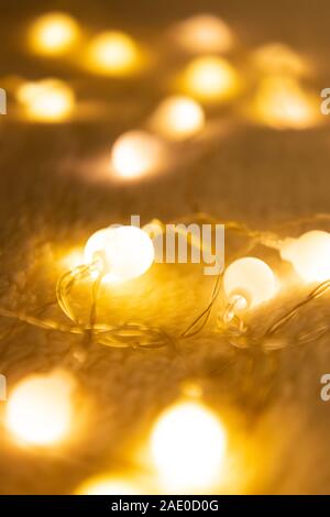 Christmas garland lights from LED bulbs on the carpet background Stock Photo