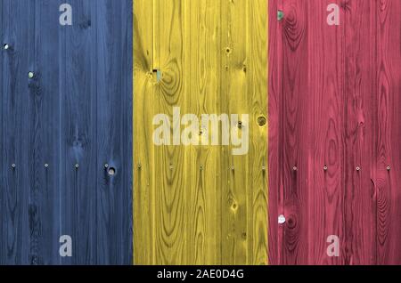 Chad flag depicted in bright paint colors on old wooden wall close up. Textured banner on rough background Stock Photo