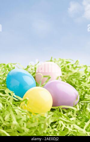 Group of plastic Easter eggs sitting on artificial green grass Stock Photo