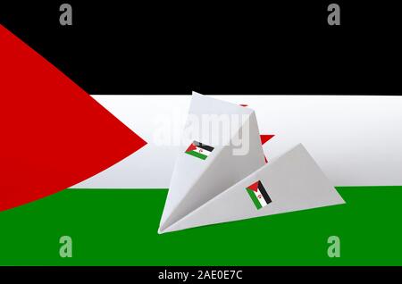 Western Sahara flag depicted on paper origami airplane. Oriental handmade arts concept Stock Photo