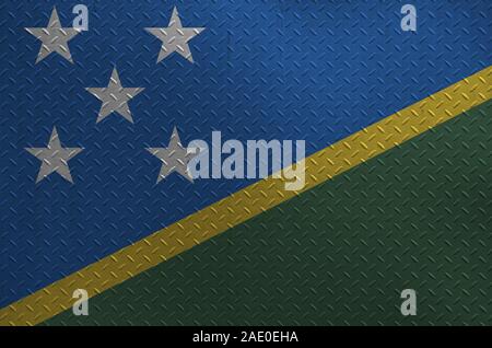 Solomon Islands flag depicted in paint colors on old brushed metal plate or wall close up. Textured banner on rough background Stock Photo