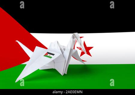 Western Sahara flag depicted on paper origami crane wing. Oriental handmade arts concept Stock Photo