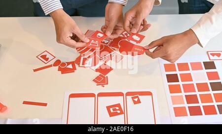 Designer ux ui working desk with compare design of screens for mobile application. Developing wireframe for mobile user experience. Stock Photo