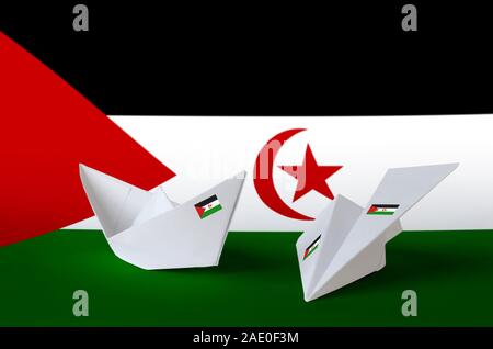 Western Sahara flag depicted on paper origami airplane and boat. Oriental handmade arts concept Stock Photo