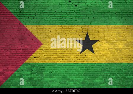 Sao Tome and Principe flag depicted in paint colors on old brick wall close up. Textured banner on big brick wall masonry background Stock Photo