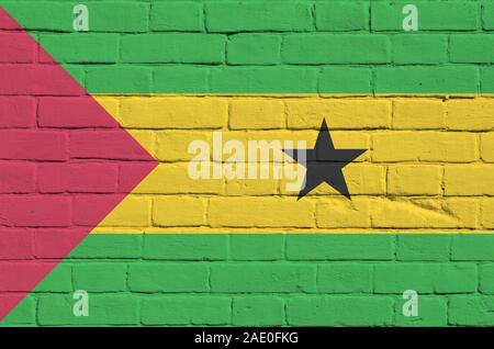 Sao Tome and Principe flag depicted in paint colors on old brick wall close up. Textured banner on big brick wall masonry background Stock Photo