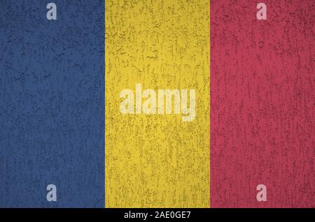 Chad flag depicted in bright paint colors on old relief plastering wall close up. Textured banner on rough background Stock Photo