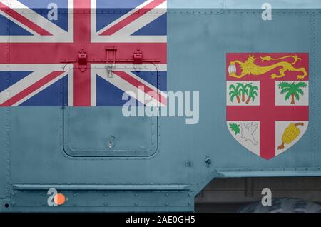 Fiji flag depicted on side part of military armored truck close up. Army forces vehicle conceptual background Stock Photo