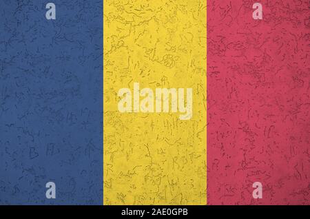 Chad flag depicted in bright paint colors on old relief plastering wall close up. Textured banner on rough background Stock Photo