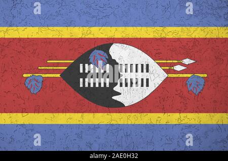 Swaziland flag depicted in bright paint colors on old relief plastering wall close up. Textured banner on rough background Stock Photo