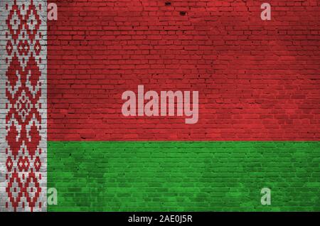 Belarus flag depicted in paint colors on old brick wall close up. Textured banner on big brick wall masonry background Stock Photo